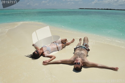 Image of happy young couple have fun on beach