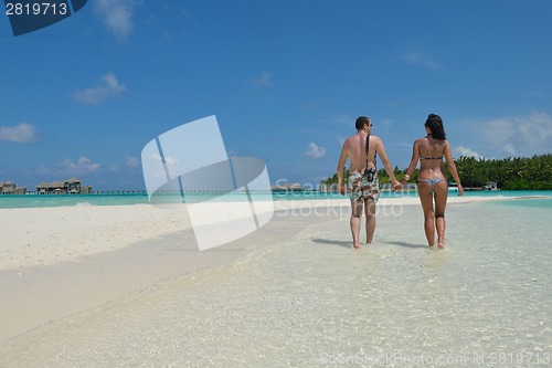 Image of happy young couple have fun on beach