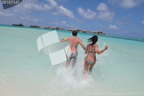 Image of happy young couple have fun on beach