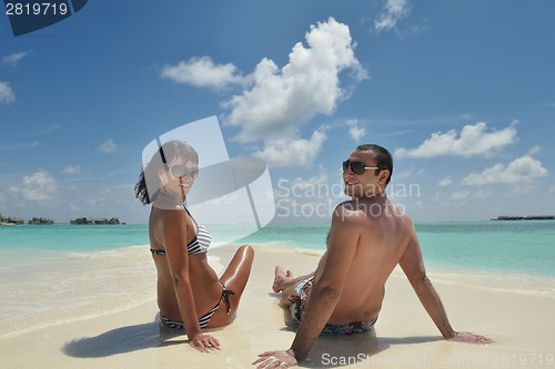 Image of happy young couple have fun on beach