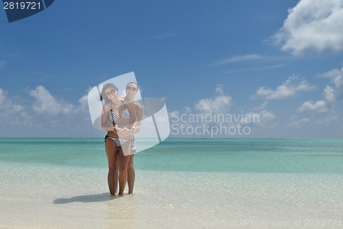 Image of happy young couple have fun on beach