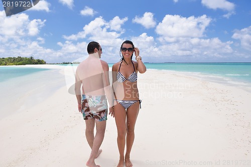Image of happy young couple have fun on beach