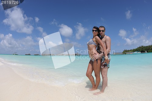 Image of happy young couple have fun on beach