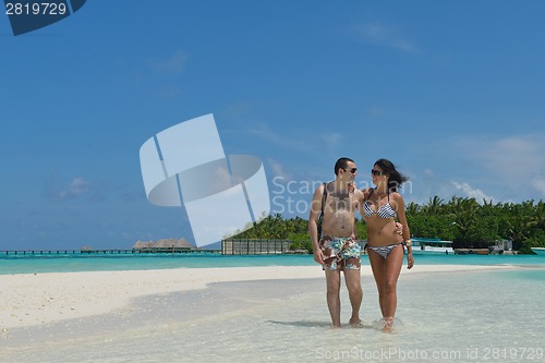 Image of happy young couple have fun on beach