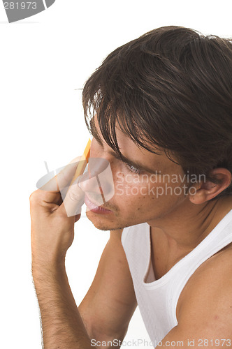 Image of close up of young man shaving