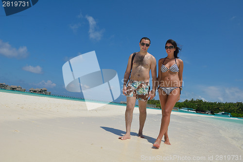 Image of happy young couple have fun on beach