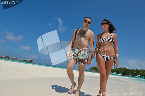 Image of happy young couple have fun on beach