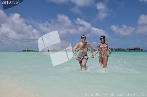 Image of happy young couple have fun on beach