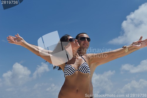Image of happy young couple have fun on beach