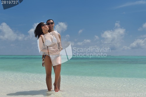 Image of happy young couple have fun on beach