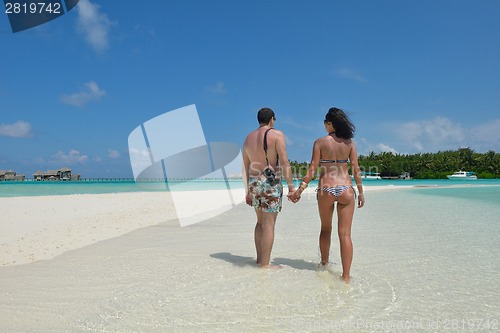 Image of happy young couple have fun on beach