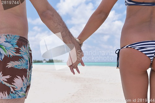 Image of happy young couple have fun on beach