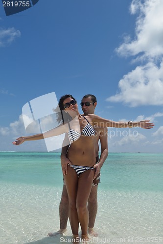 Image of happy young couple have fun on beach