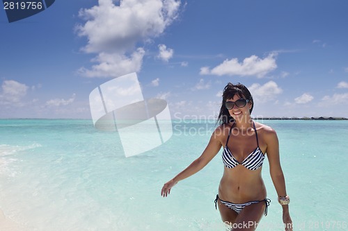 Image of beautiful young woman  on beach have fun and relax