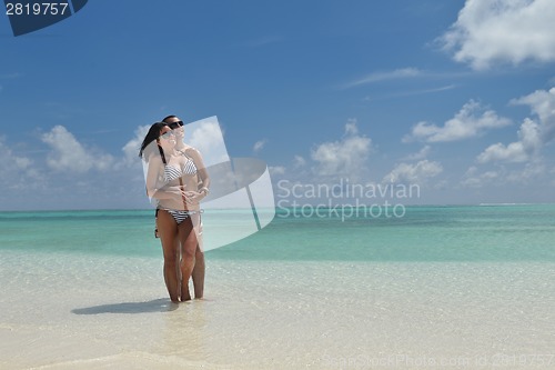 Image of happy young couple have fun on beach
