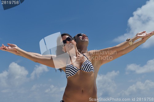 Image of happy young couple have fun on beach