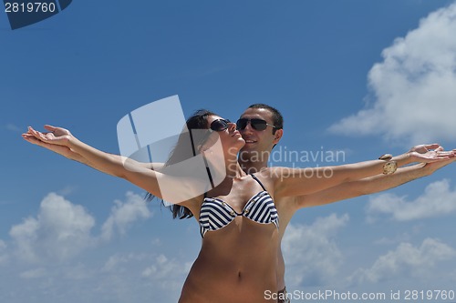 Image of happy young couple have fun on beach