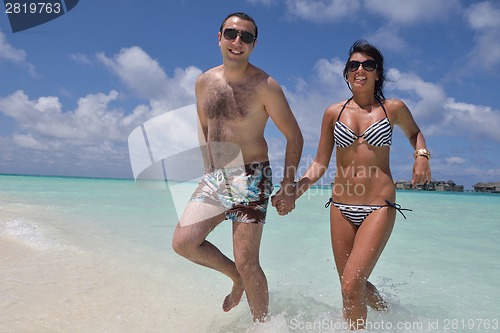 Image of happy young couple have fun on beach
