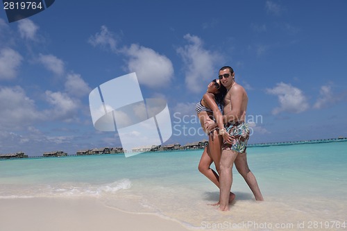 Image of happy young couple have fun on beach