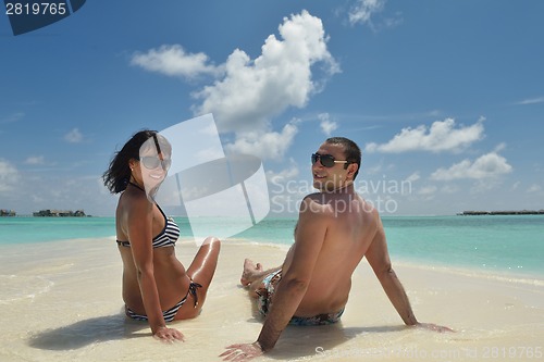 Image of happy young couple have fun on beach