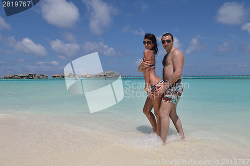 Image of happy young couple have fun on beach