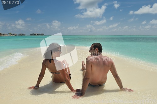 Image of happy young couple have fun on beach