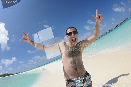 Image of young man have fun and relax on beach