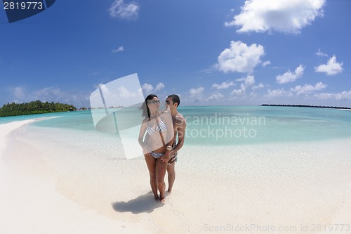 Image of happy young couple have fun on beach