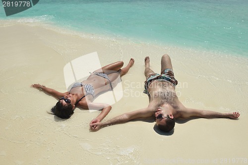 Image of happy young couple have fun on beach