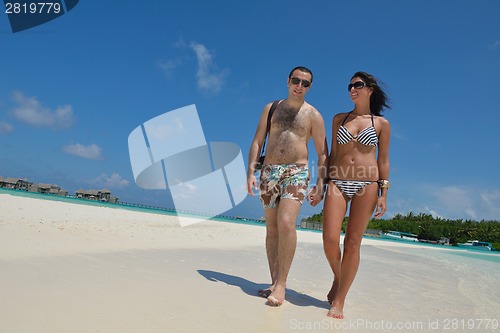 Image of happy young couple have fun on beach