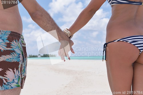 Image of happy young couple have fun on beach
