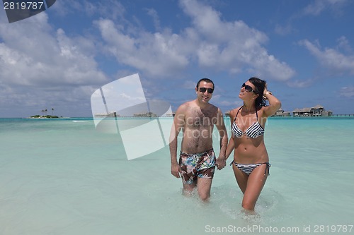 Image of happy young couple have fun on beach