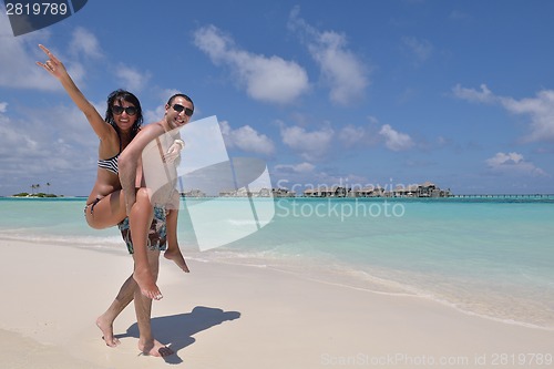 Image of happy young couple have fun on beach