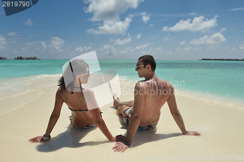 Image of happy young couple have fun on beach