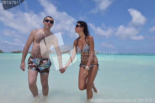 Image of happy young couple have fun on beach