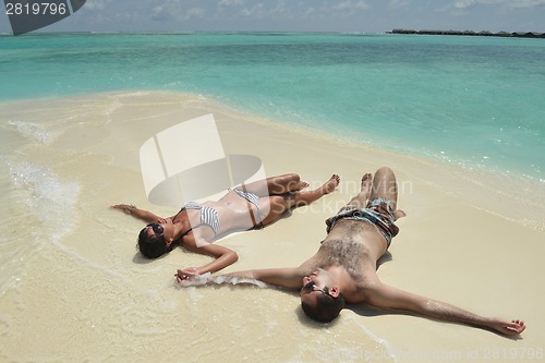 Image of happy young couple have fun on beach