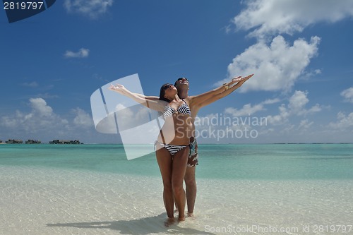 Image of happy young couple have fun on beach