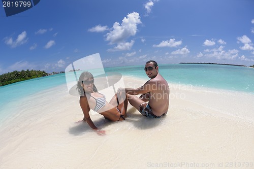 Image of happy young couple have fun on beach