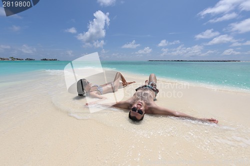 Image of happy young couple have fun on beach