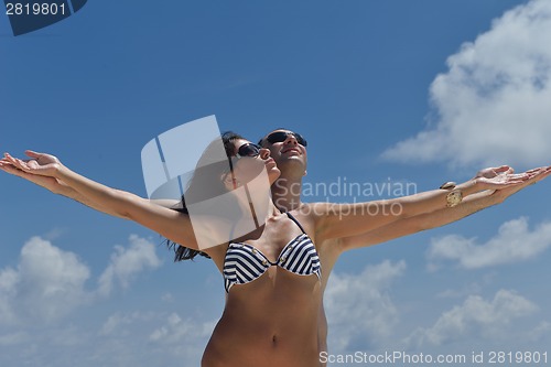 Image of happy young couple have fun on beach