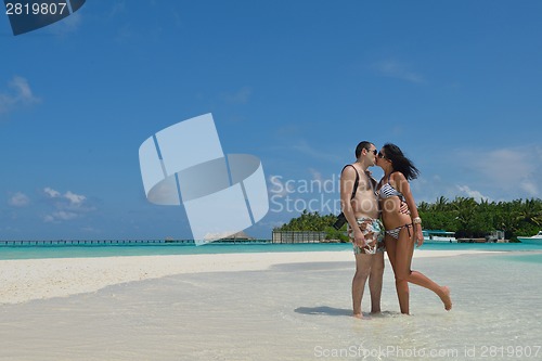 Image of happy young couple have fun on beach