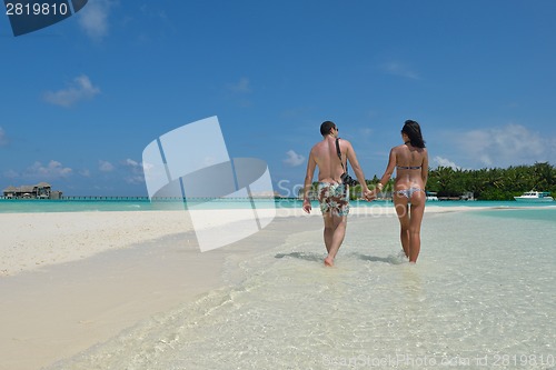 Image of happy young couple have fun on beach