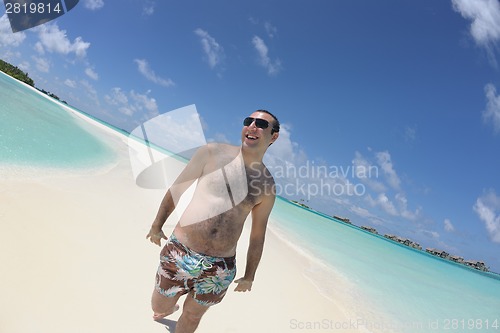 Image of young man have fun and relax on beach