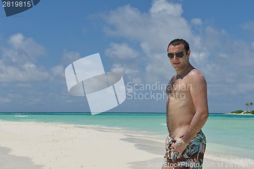 Image of young man have fun and relax on beach