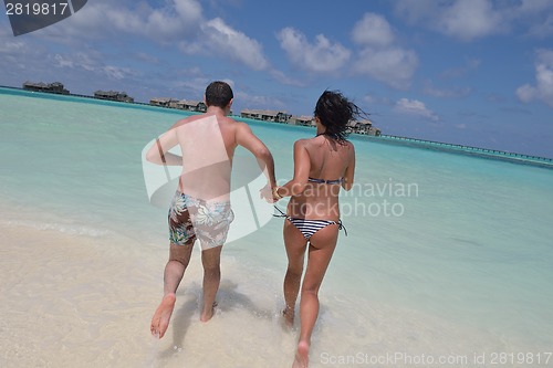 Image of happy young couple have fun on beach