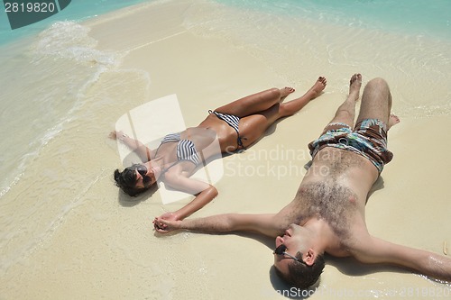 Image of happy young couple have fun on beach