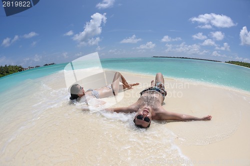 Image of happy young couple have fun on beach