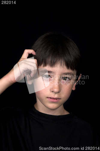 Image of boy scratching his head