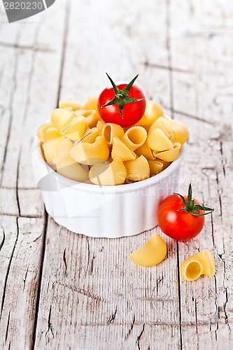 Image of uncooked pasta and cherry tomatoes in a bowl 