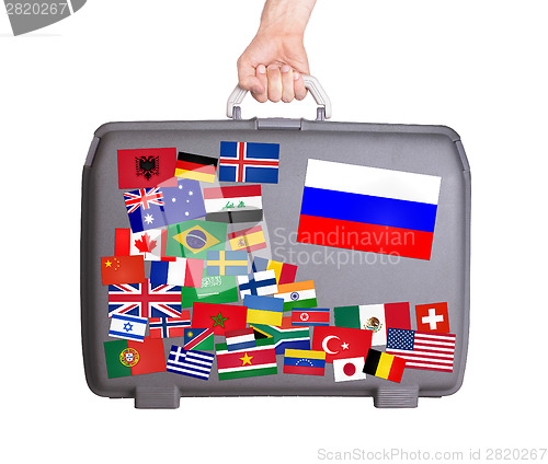 Image of Used plastic suitcase with stickers